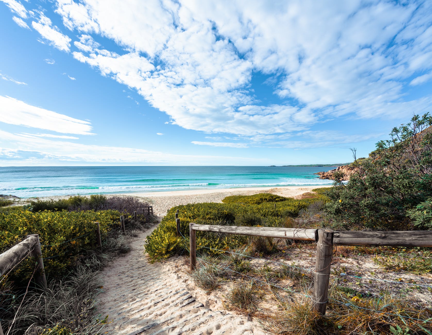 wooden path leading to azure sea